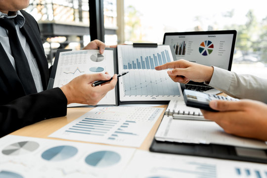 Business Corporate team brainstorming, Planning Strategy having a discussion Analysis investment researching with chart at office his desk documents and saving concept