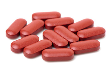 Obraz na płótnie Canvas Red pills on a white background