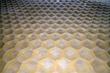 Fototapeta premium Wide angle macro shot of honeycomb wax. Abstract view of honey comb hexagon shape pattern