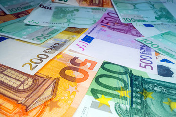 Wide angle view of euro notes background stacked on top of each other. Euro money banknotes, pile of money, cash, stack of bills. Investing money, savings
