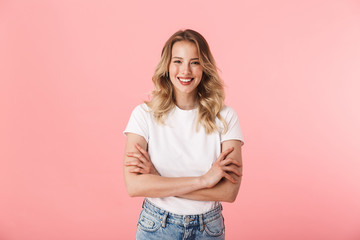 Beautiful young blonde woman posing isolated over pink wall background. - obrazy, fototapety, plakaty