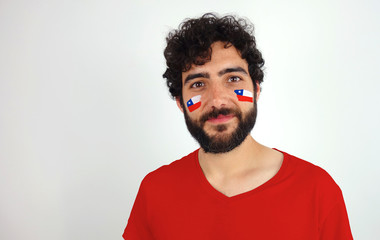 Sport fan smiling looking at camera. Man with the flag of Chile makeup on his face and red t-shirt.