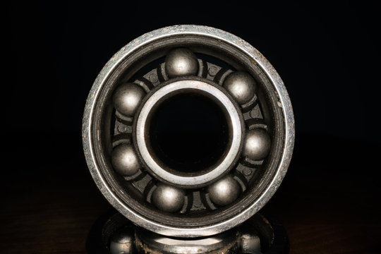 Macro shot of stainless steal bearing. New replacement roller skate bearings isolated on black background. Standard ABEC type bearing for inline skates, skateboard, long board or scooters