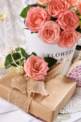 bunch of roses and a gift in romantic style