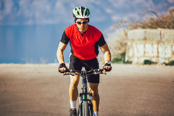 Man ride mountain bike on the road. Sport and active life concept.