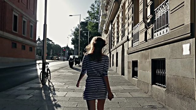 Young girl walks through the streets of Madrid