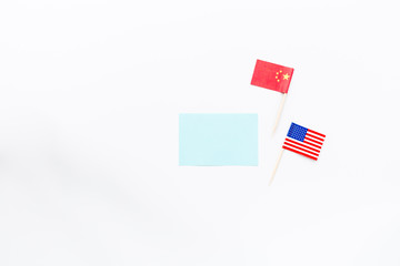 Creative top view flat lay of China and USA flag, mockup and copy space on white background in minimal style. Concept of trade war between USA and China