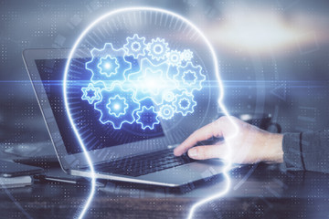 Man typing on keyboard background with brain hologram. Concept of big Data. Double exposure.