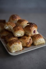 Croissant in plate on wooden table.