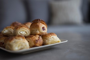 Croissant in plate on wooden table.