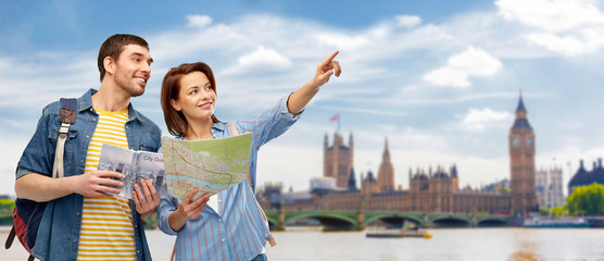 travel, tourism and vacation concept - happy couple of tourists with city guide, map and backpacks...