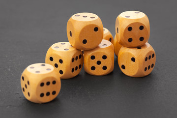 Rolling dice on a wooden desk