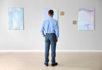 Fototapeta premium Man at exhibition in modern art gallery