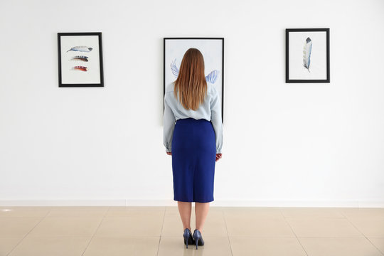 Woman at exhibition in modern art gallery
