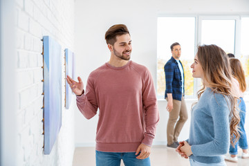 People at exhibition in modern art gallery