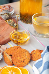 Cup with herbal tea and honey and dry herbal tea