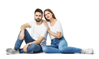 Stylish young couple in jeans on white background