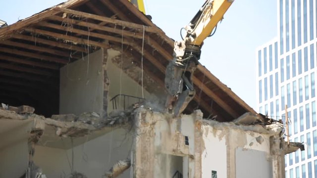 High Reach Excavator Demolishing House