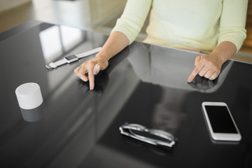 technology and people concept - close up of woman using black interactive panel