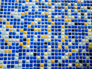 Fototapeta premium Fragment of beautiful mosaic on the facade of the building. Abstract colored ceramic puzzles as decorative background.