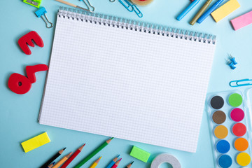 Back to school. Items for the school on a blue table.