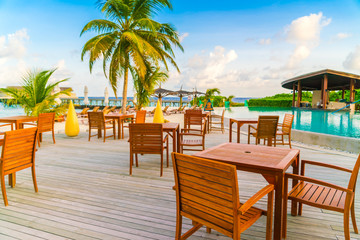 Table and chairs at restaurant in tropical Maldives island .