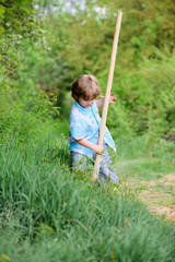 Little boy with shovel looking for treasures. Happy childhood. Adventure hunting for treasures. Little helper working in garden. Cute child in nature having fun with shovel. I want to find treasures