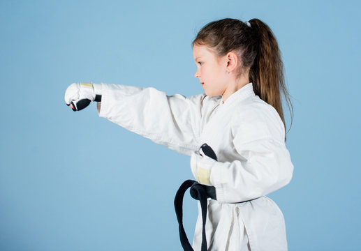 Sport Success In Single Combat. Practicing Kung Fu. Happy Childhood. Little Girl In Gi Sportswear. Small Girl In Martial Arts Uniform. Knockout. Energy And Activity For Kids. Free Your Mind