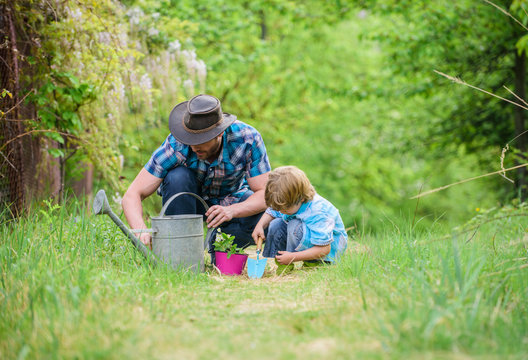 Eco farm. watering can, pot and hoe. Garden equipment. small boy child help father in farming. father and son in cowboy hat on ranch. happy earth day. Family tree nursering. Help and support