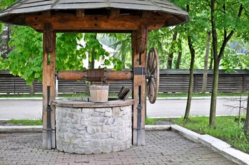 Close up of an wooden old traditional well in the country side. 