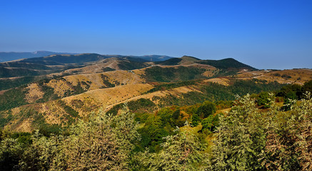 Fototapeta na wymiar panorama of mountains with blue sky in Russia Krasnodar region