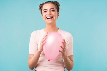 smiling brunette with a pink balloon 