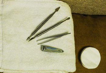 Manicure tools on a white towel. Scissors, nail file, sticks, etc.