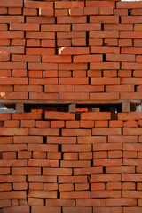 Construction Materials. Pile of red bricks at construction site. Building materials for construction of buildings and structures. Close up.