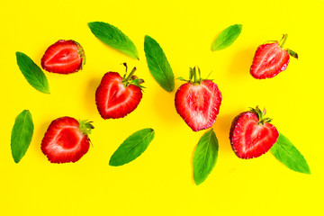  Strawberries and mint leaves on a bright yellow background. Background for the design of banners, websites, blogs. 