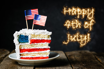 American national holidays concept - 4th of July, layered spounge cake in USA flag colours, rustic background, copy space