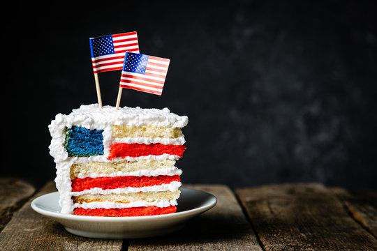 American national holidays concept - 4th of July, Memorial Day, Labour Day. Layered spounge cake in USA flag colours, rustic background, copy space