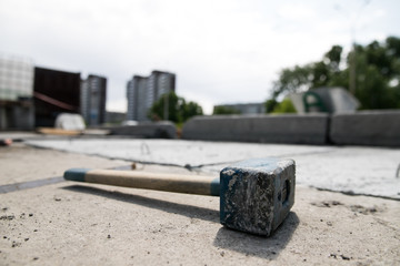 Construction iron sledgehammer lying on the sidewalk