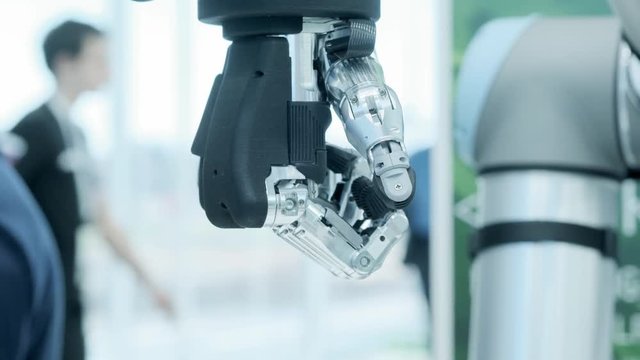 Modern technology today. Robotic human arm is a manipulator. Modern prosthetic limbs. Future is now. The thumb is moving to the right. Futuristic bionic arm