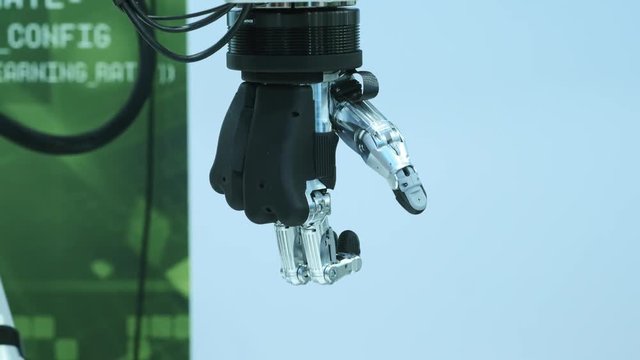 Modern technology today. Robotic human arm is a manipulator. Modern prosthetic limbs. Future is now. The thumb is moving to the right. Futuristic bionic arm