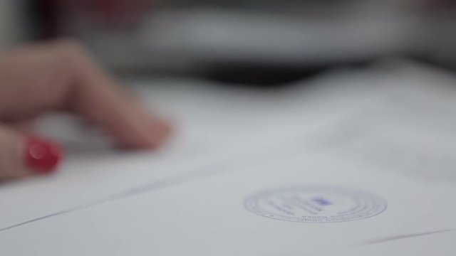 Woman puts the print stamp on documents