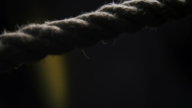 Hand pulls the rope close up