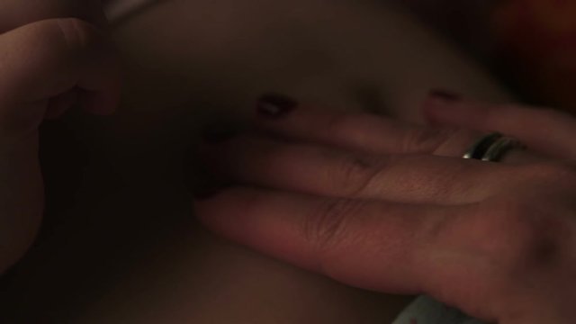 Mother stroking tummy hurts child