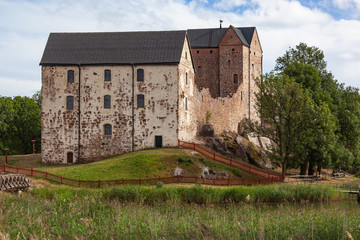 Fototapeta na wymiar Medieval Kastelholm Castle (built in 14th century) on the hill on the shore of fjord, Aland islands, Finland