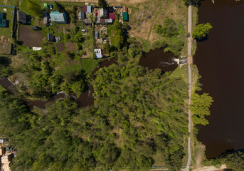 Fototapeta premium A pond in the Kamenka village, a dam and road. Sunny, summer, Aerial