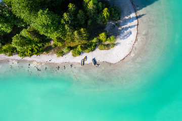 Beach at Walchensee Lake. turquoise water. Small Boats on the shore. Aerial Shot