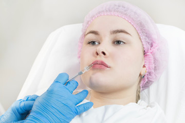 The procedure of surgical correction of the lips of a young girl in the clinic
