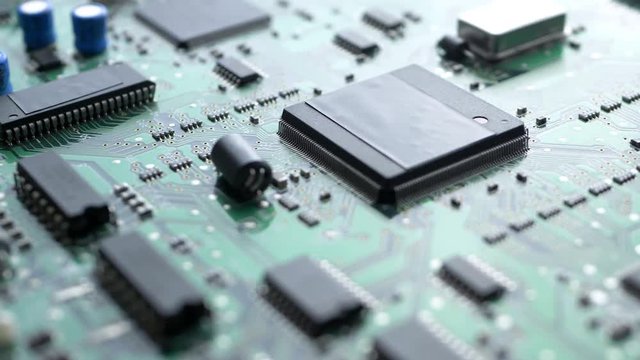 Electronic circuit board with processor, chips and capacitors. Tech science background