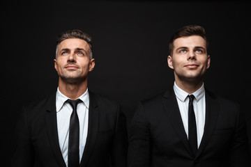 Two confident handsome businessmen wearing suit