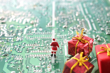 パソコンの基盤の上でクリスマスプレゼントを配るサンタクロース